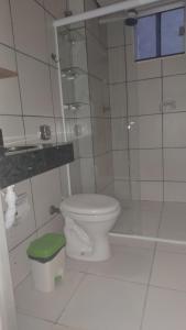 een witte badkamer met toilet en douche bij Sossego1 in Várzea Grande