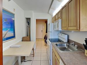 a kitchen with a sink and a counter top at Harbour Beach Resort 203 in Seabreeze