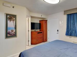 a bedroom with a bed and a flat screen tv at Harbour Beach Resort 203 in Seabreeze