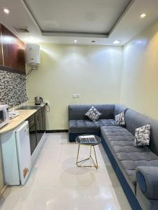 a living room with a couch and a table at تاج 2 in Al Kharj