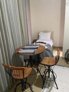 um quarto com uma mesa, cadeiras e uma cama em Vila Marias em Ouro Preto