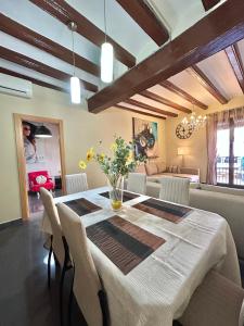 a dining room with a table and chairs at Font 1 Circo Romano in Tarragona +17 photos