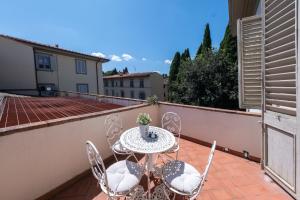 a patio with a table and chairs on a balcony at Serristori Palace Residence in Florence +40 photos