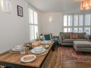 a living room with a table and a couch at Betty's Buoy in Weymouth