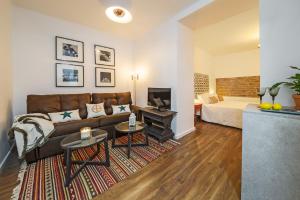 a living room with a couch and a fireplace at Apartamentos Los Venerables in Seville