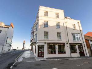 a large white building on the side of a street at Betty's Buoy in Weymouth