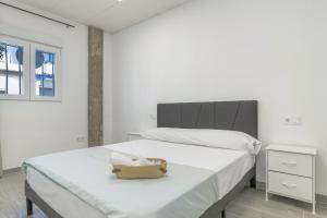 a bedroom with a bed with a basket on it at Apartamento Ajm in Barbate