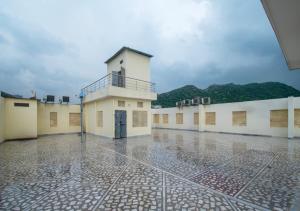 a large building with a tower on top of it at Amer Classic - A Heritage Stay Near Amer Fort in Jaipur