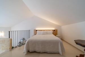 Ένα ή περισσότερα κρεβάτια σε δωμάτιο στο Masseria dei Monaci +39 φωτογραφίες