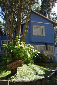 a blue house with a sign in front of it at La casa de los Abuelos in Costa del Este