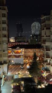 a view of a city at night with a christmas tree at Gloria New Bazaar Apartment in Tirana
