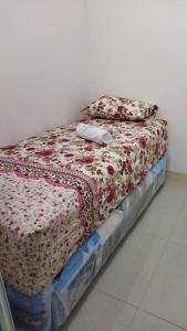 a bed with two pillows on top of it at Properti9 at Apartemen Green Pramuka in Jakarta +2 photos