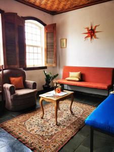 a living room with a couch and a table at Apto Gatinho in Rio de Janeiro