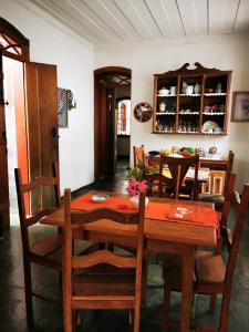 a dining room with a wooden table and chairs at Apto Gatinho in Rio de Janeiro