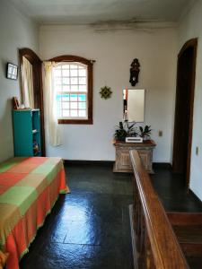 a bedroom with a bed and a window at Apto Gatinho in Rio de Janeiro
