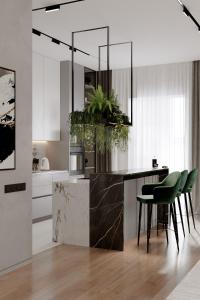 a kitchen with a island with green chairs in it at Ático de lujo para 7 personas in Cartagena de Indias