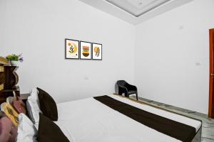 a bedroom with a bed with white sheets at HOTEL O ROYAL SIDHAULI in Manwān