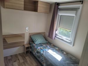a small bedroom with a bed and a window at bb - Confort & charme - Au Cœur de l'Occitanie, 3 ch,2 sdb, entre mer et campagne in Lattes +32 photos