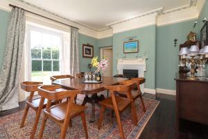 a dining room with a wooden table and chairs at The Old Vicarage in Wadebridge