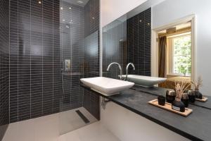 a black and white bathroom with a sink and a mirror at The Old Vicarage in Wadebridge +19 photos