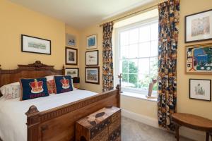 a bedroom with a wooden bed and a window at The Old Vicarage in Wadebridge