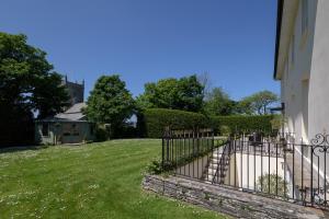 a fence in a yard next to a house at The Old Vicarage in Wadebridge