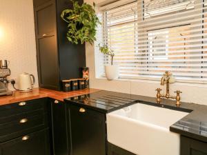 a kitchen with a white sink and a window at Ivy's End in Loughborough +38 photos