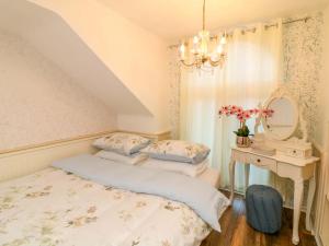 a bedroom with two beds and a table with a mirror at Ivy's End in Loughborough