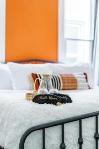 a tray with a glass pitcher on a bed at Jungle House Luxury Stays - Columbus Downtown Short North in Columbus