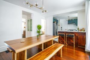 a dining room with a wooden table in a kitchen at Jungle House Luxury Stays - Columbus Downtown Short North in Columbus