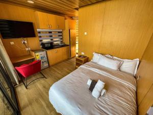 a bedroom with a bed with two towels on it at Adepa in Kokrobite