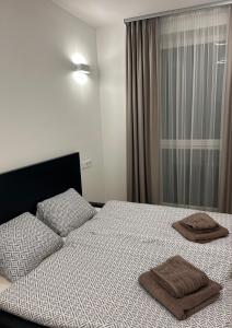 a bedroom with a bed with two towels on it at Fresh Garden Casa Mimo in Siófok +17 photos