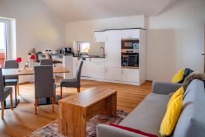 a living room with a couch and a table at Mahdgut in Ramsau