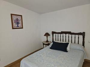 a bedroom with a bed with a blue comforter at CASA RURAL LLAVADOR Vall Guadalest in Benifató