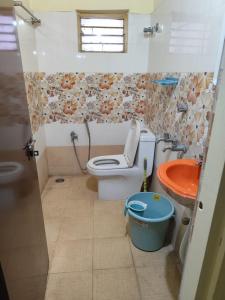 a bathroom with a toilet and a sink at lighten homestay in Visakhapatnam