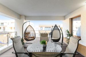 a patio with a table and chairs on a balcony at Luxury 2BR Apartment - Amazing Terrace in Braşov