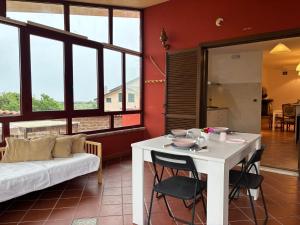 a living room with a table and a couch at Villa Ninnì in Treglio