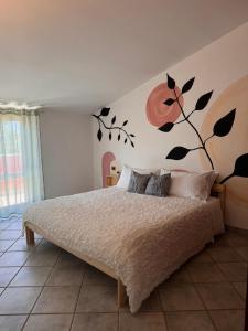a bedroom with a bed with a tree mural on the wall at Villa Ninnì in Treglio +16 photos