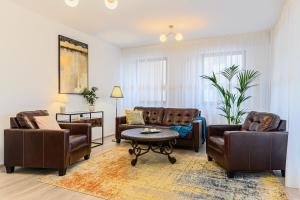 a living room with two couches and a coffee table at Luxury 2BR Apartment - Amazing Terrace in Braşov