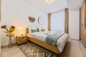 a bedroom with a large bed and a window at Luxury 2BR Apartment - Amazing Terrace in Braşov