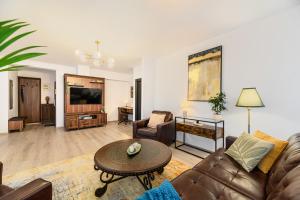 a living room with a couch and a table at Luxury 2BR Apartment - Amazing Terrace in Braşov