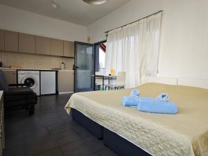 a bedroom with a bed with two towels on it at St. Lazaros Studios in Larnaca