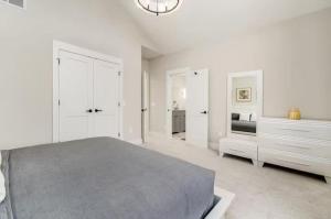 a white bedroom with a large bed and white cabinets at Jungle House Columbus Short North Downtown Free Parking - Near Convention Center & Nationwide Arena - 6BR Luxury Home - Sleeps 32 - Over 5,800 Five Star Stays in Columbus