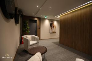 a lobby with a waiting room with a chair and a table at Resort Anes Drinit in Peje
