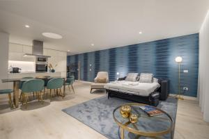 a living room with a bed and a kitchen at Land Roots Riverside Apartments in Vila Nova de Gaia