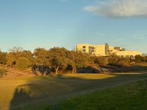a shadow of a person on a golf green at Hospedium Hotel Valles de Gredos Golf in Talayuela