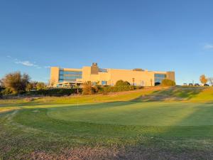 a golf course with a building in the background at Hospedium Hotel Valles de Gredos Golf in Talayuela
