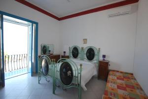 a bedroom with a bed and a window at Oasi 2 terrace overlooking the sea in Canneto in Canneto - Lipari