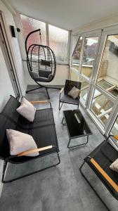 a living room with two chairs and a swing at Lichtblick in Goldbach