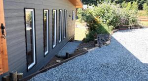 un lato di una casa con una porta e alcune rocce di Casa de montaña con vista espectacular a Villarrica Altre 47 foto